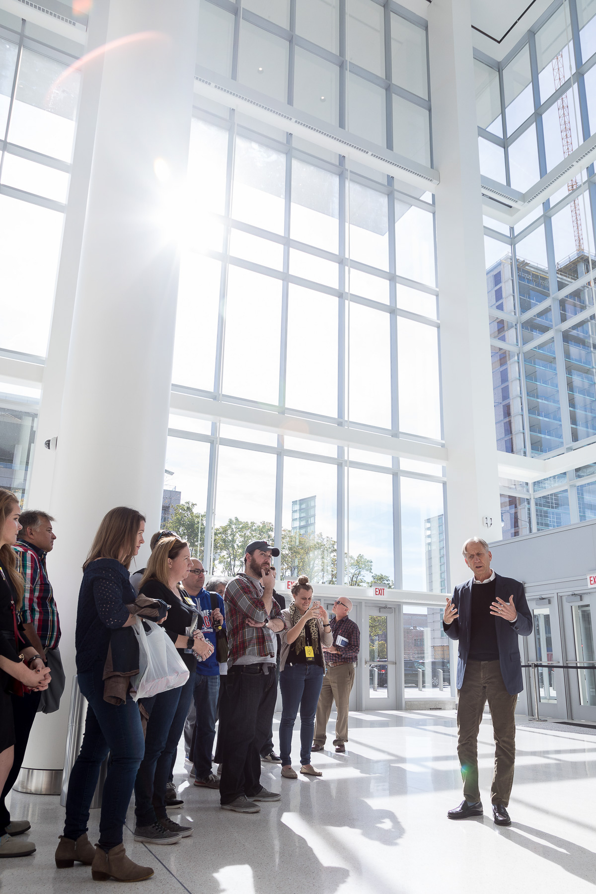 Mitchell Hirsch, principal architect for Pelli Clarke Pelli Architects, speaks to attendees in the atrium of Wintrust Arena during a sneak peek tour. (DePaul University/Jeff Carrion)